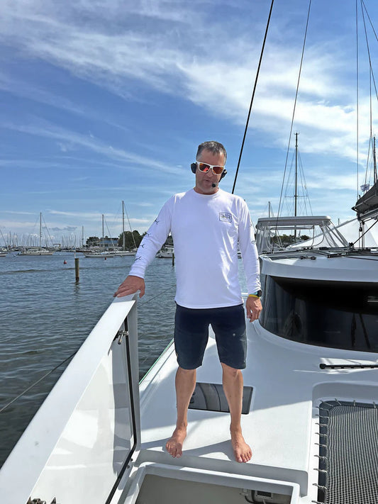 Man wearing 2Talk Bluetooth Headset on a boat.