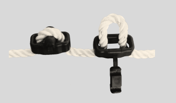 Two black rope stretchy holders with white ropes to use when at dock or when you need extra flex on a sailboat