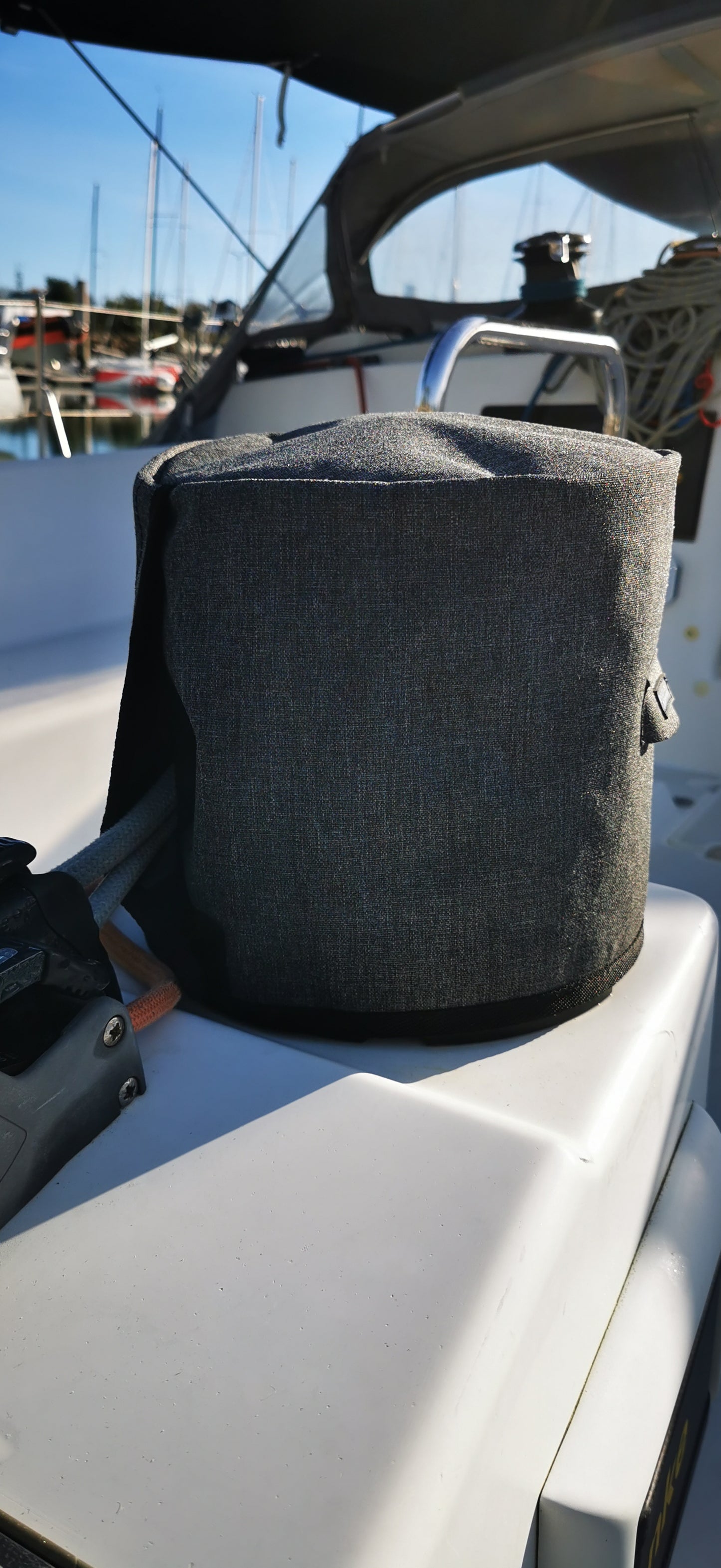 Back side of winch cover by outils oceans with a marina in the background