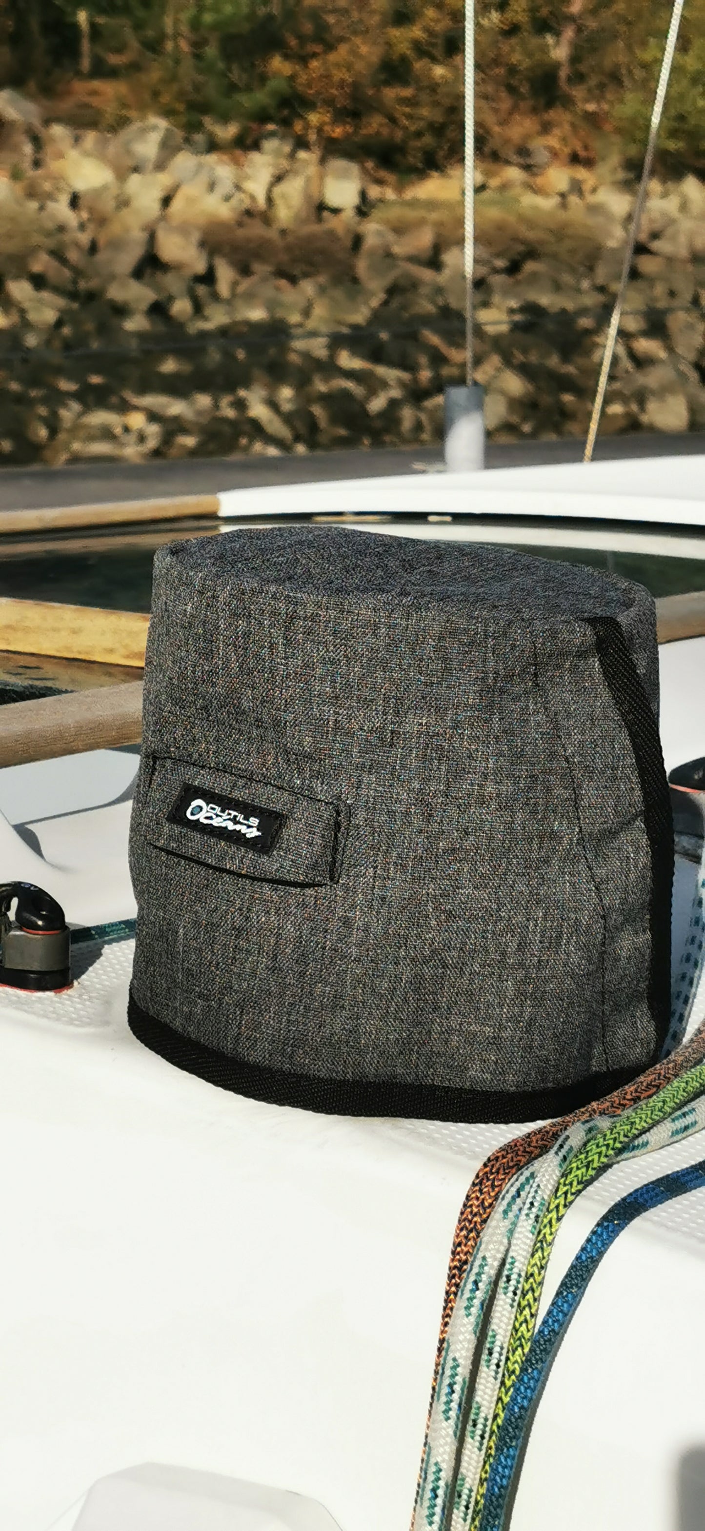 Gray winch cover  with a brand logo on a boat deck