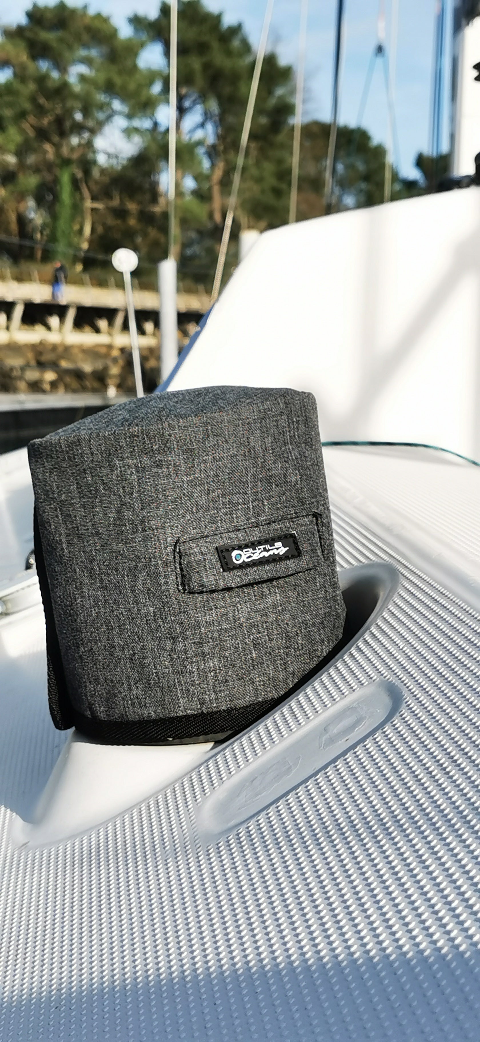 Gray bag with a brand logo on a boat seat