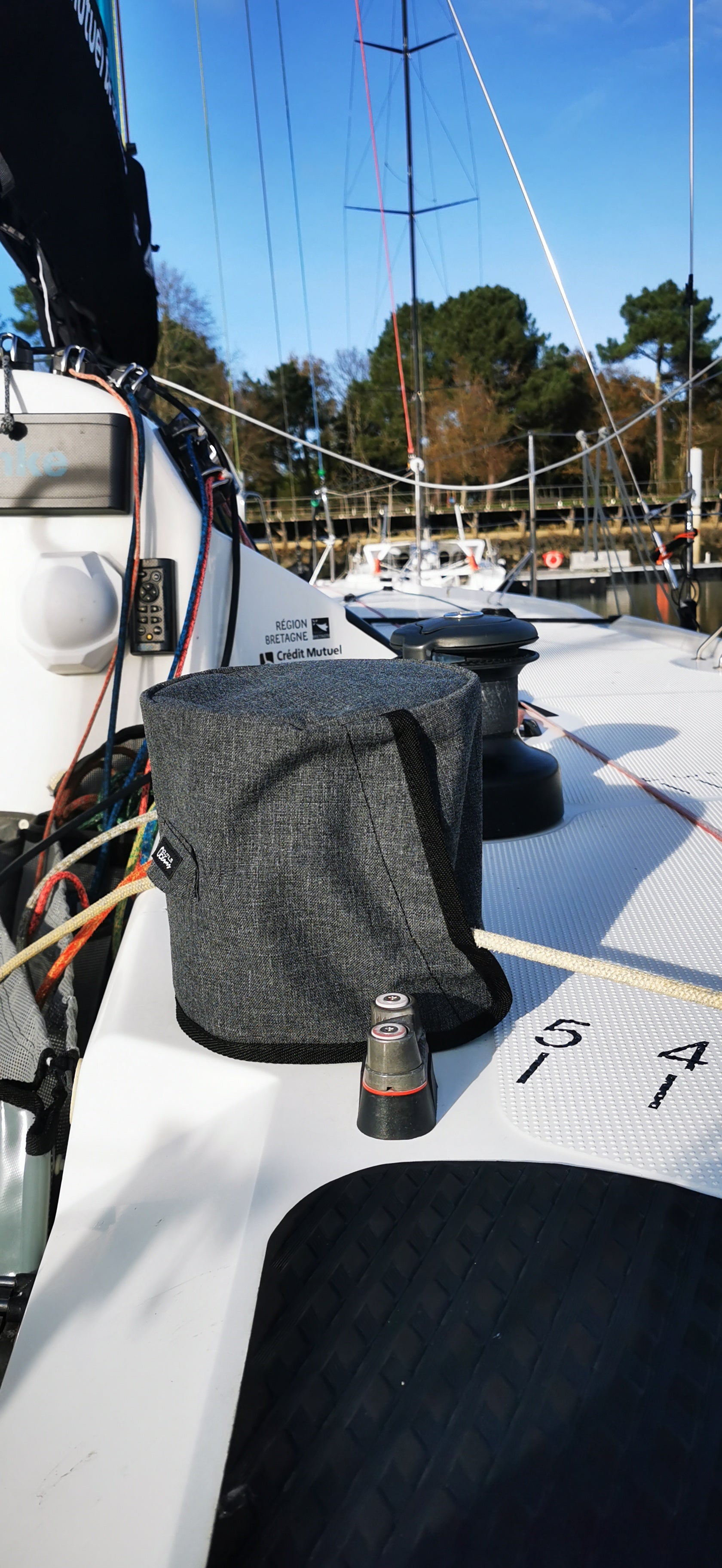 Gray bag on a boat with a marina background